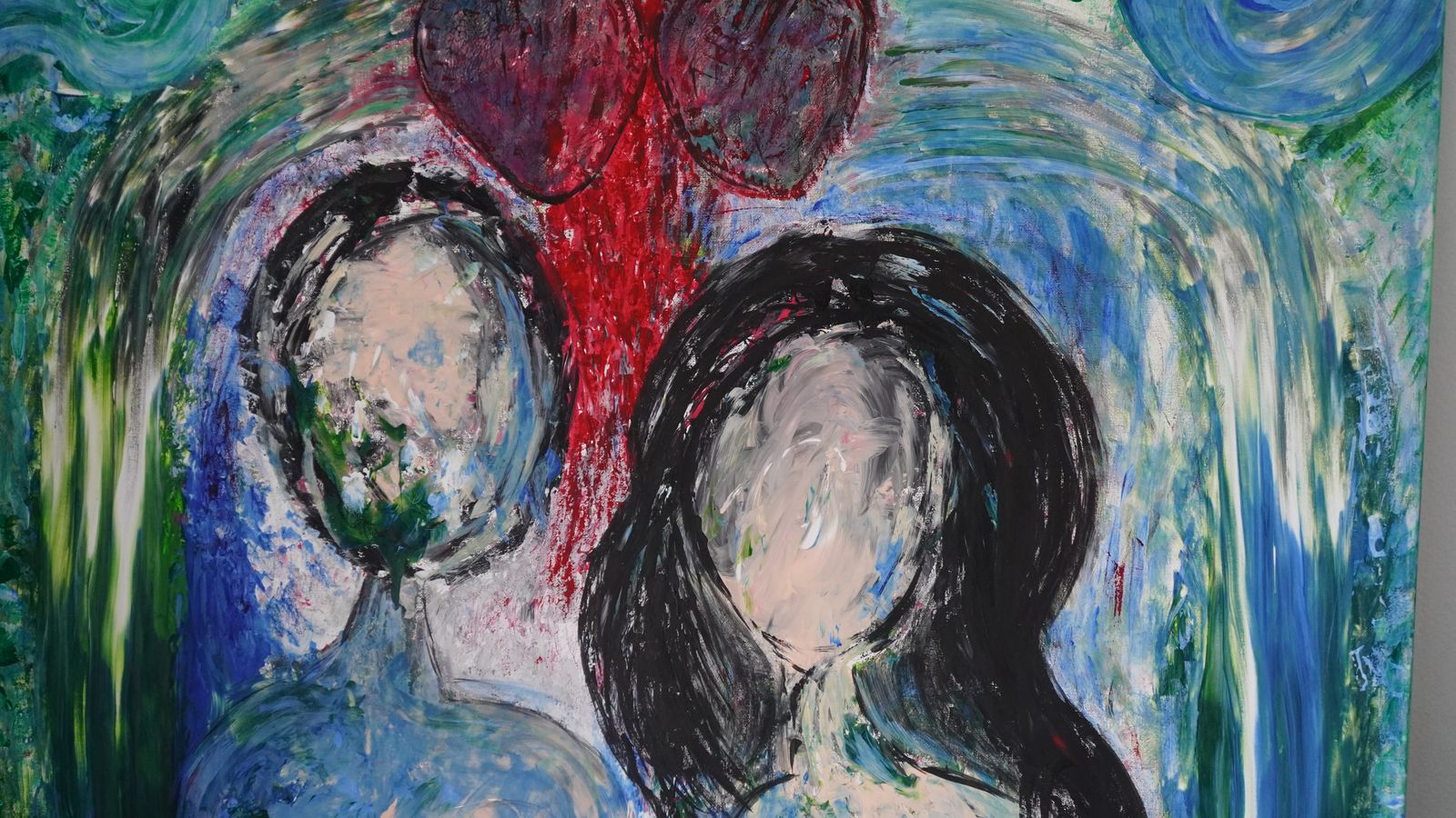 Two figures with red heart, blues and greens