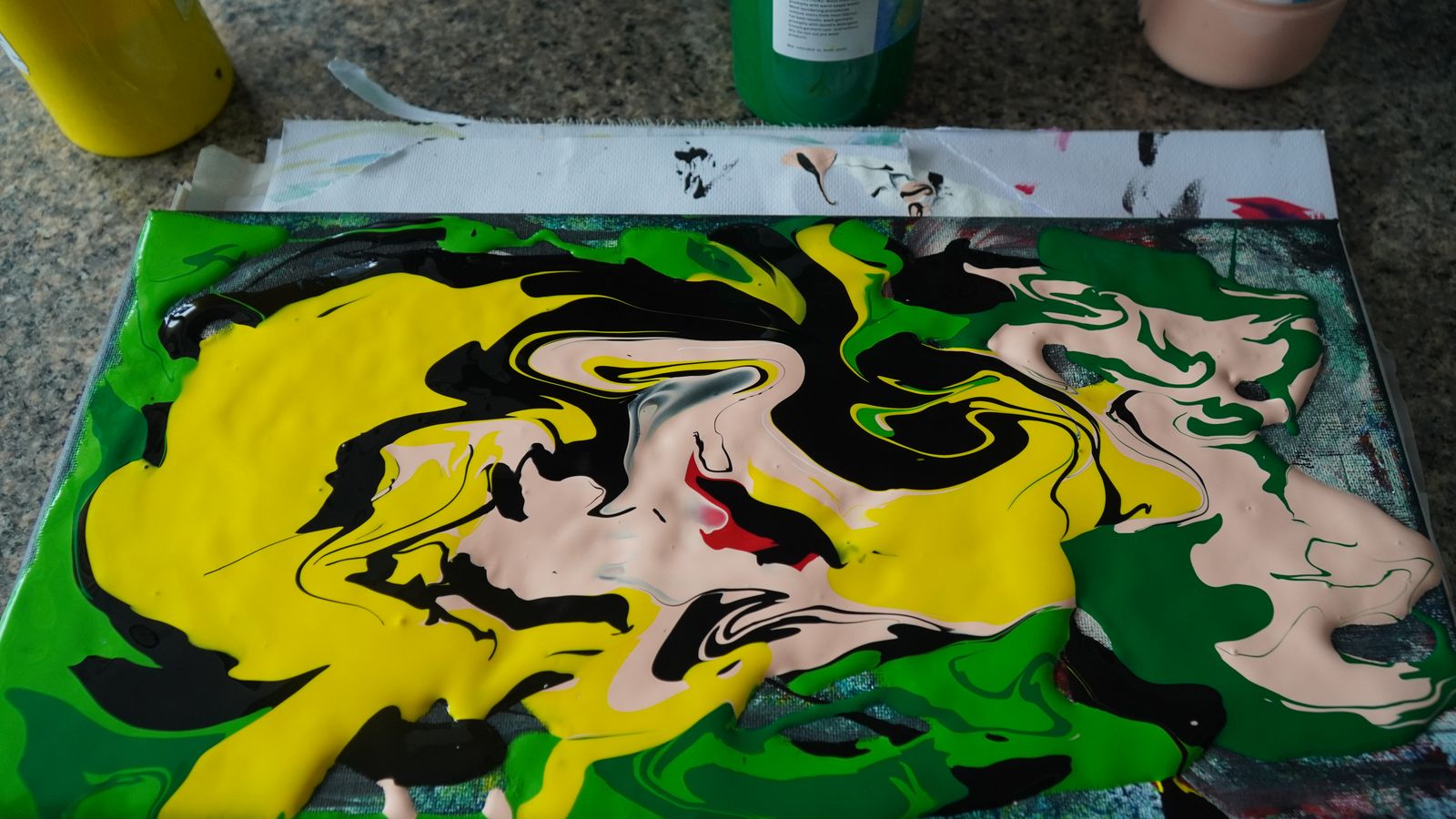 Pour painting in yellow, green, and black